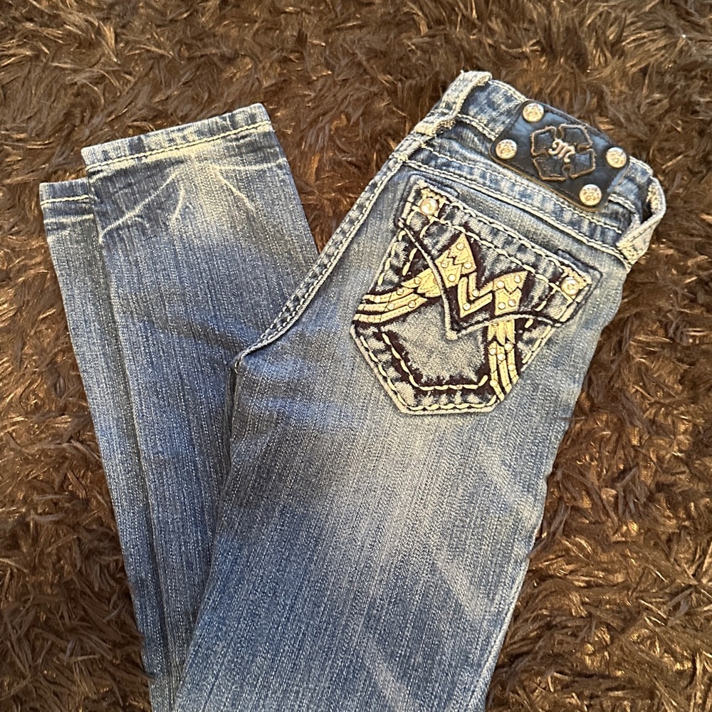 Girls size 7 Miss Me jeans Embellished back pockets. Fading by design.